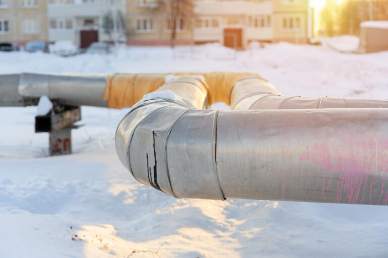 industrial pipelines covered in snow. construction.